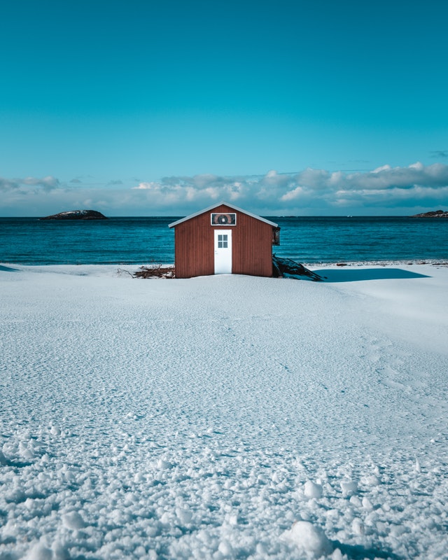 brown wooden house in the snow