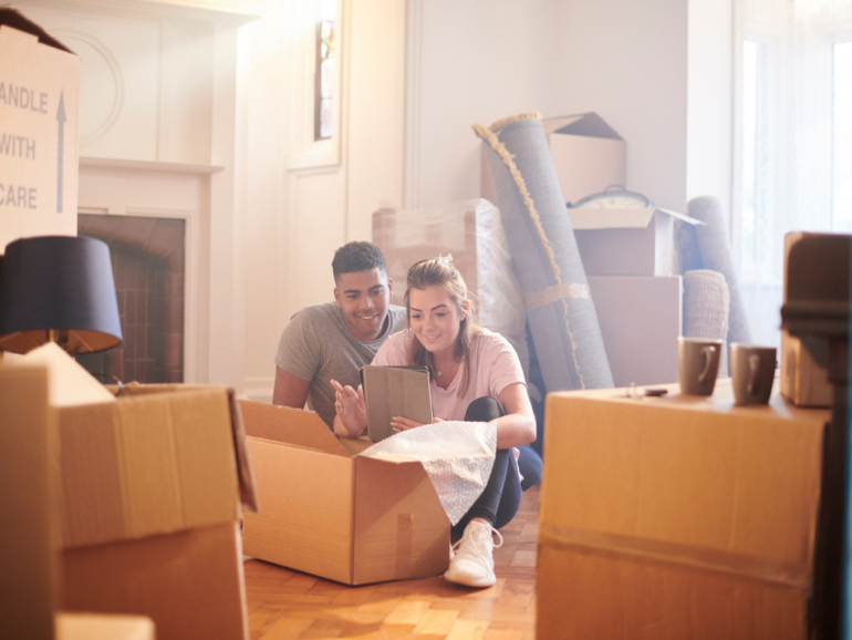 couple in new house with moving boxes