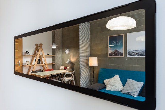 A mirror in a small living room.