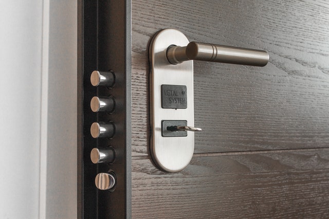 a metal lock and wooden door