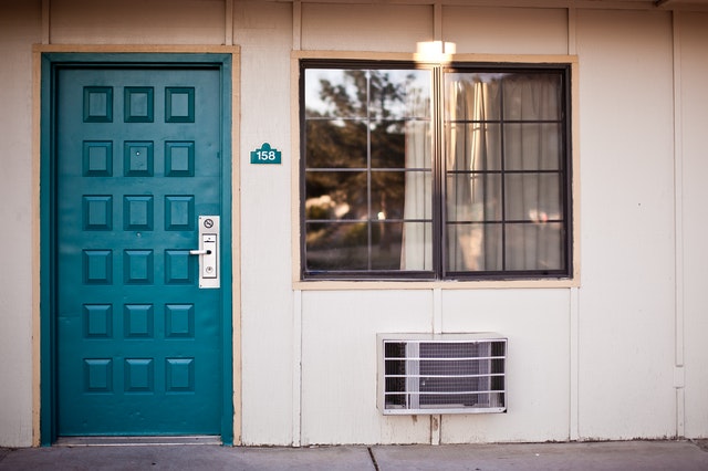 blue front door with grey lock and a window