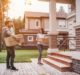 Couple moving in to new home holding boxes