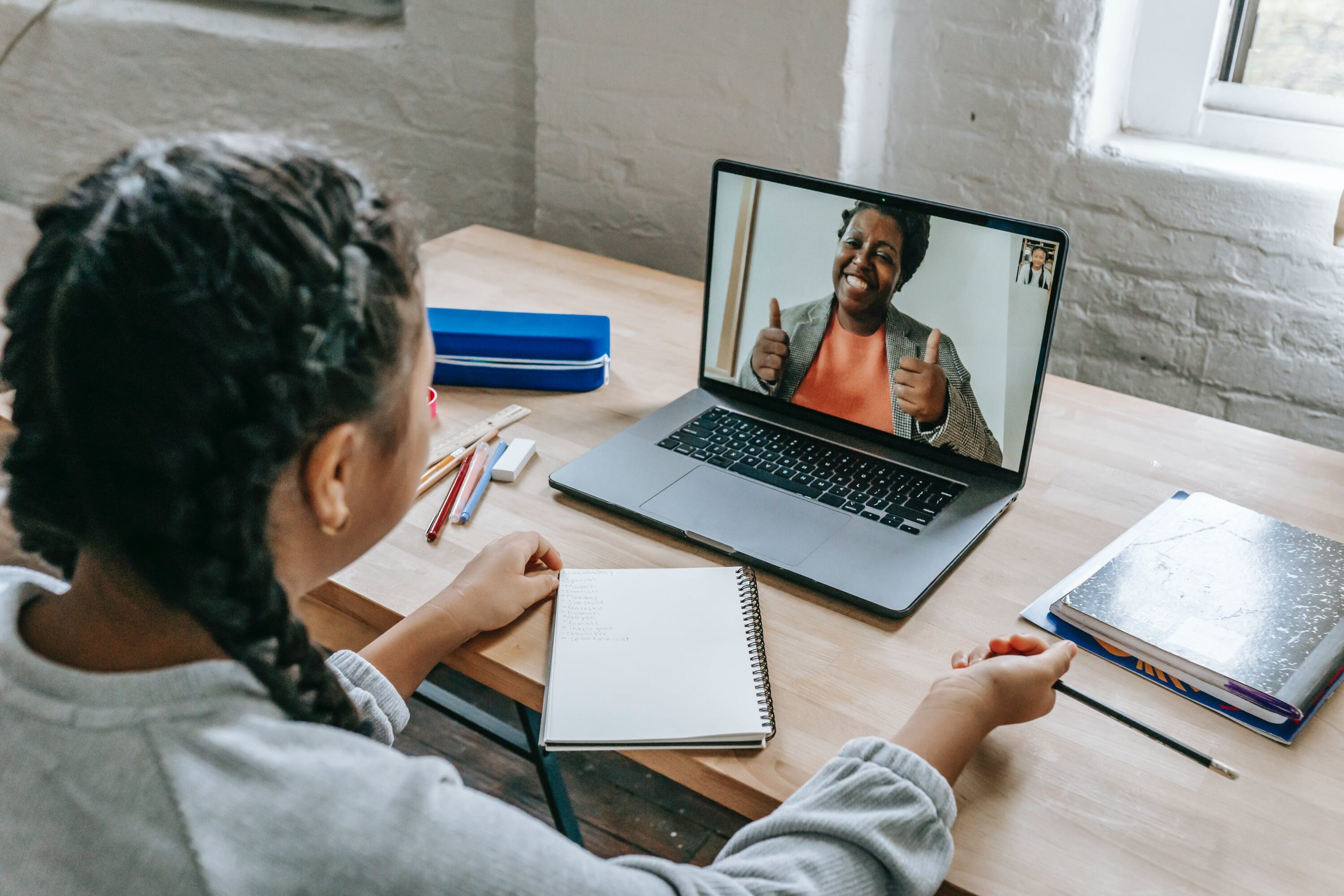 girl video conferencing with a tutor